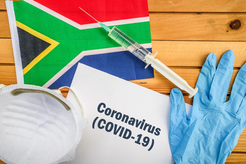 Flag of South Africa, vaccine, face mask for virus, glove and paper sheet with words Coronavirus COVID-19 Flag of South Africa, vaccine, face mask for virus, glove and paper sheet with words Coronavirus COVID-19