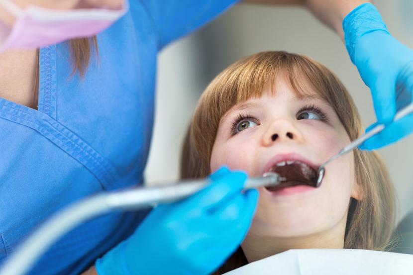 Female dentist and child in a dentist office Female dentist and child in a dentist office