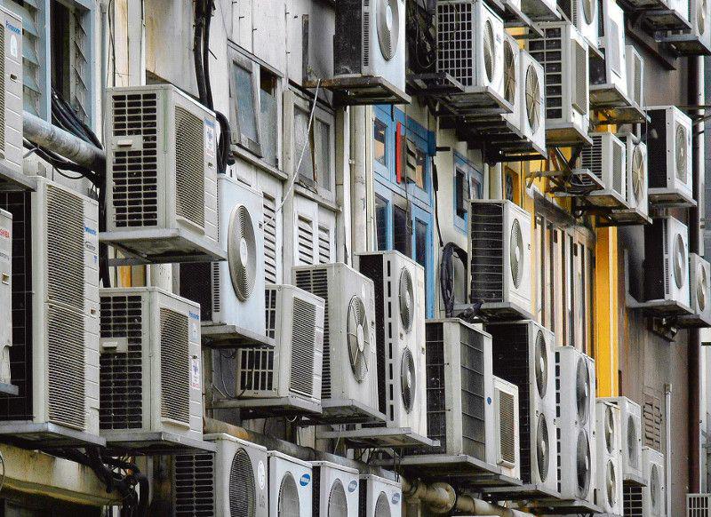 ZALEŻNIE OD MIEJSCA: Nie w każdym polskim mieszkaniu można bez przeszkód zamontować instalację klimatyzacyjną. Często nie wyrażają na to zgody wpółnoty mieszkańców i trzeba przyznać, że nieraz trudno odmówić im racji. Zdarza się bowiem, że wiszące na ścianach agregaty psują wygląd budynków. [FOT. BLOOMBERG]