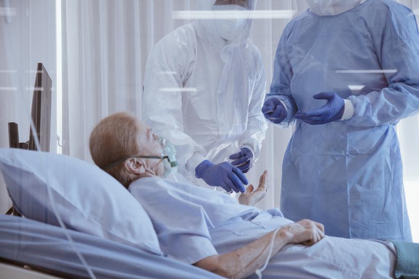 Infected patient on takecare of Doctor and nurse with x-ray Lung in quarantine lying on bed in hospital from coronavirus covid 19 disease. Covid19 or corona virus is world global social issue concept. Infected patient on takecare of Doctor and nurse with x-ray Lung in quarantine lying on bed in hospital from coronavirus covid 19 disease. Covid19 or corona virus is world global social issue concept.