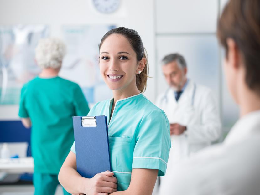 Young female medical student working at the hospital and medical staff, she is holding medical records
